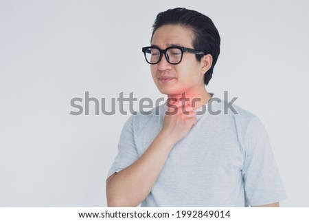 photo of Asian man with sore throat Royalty-Free Stock Photo #1992849014