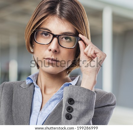 portrait of an executive young woman putting on her glasses