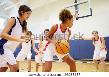 Female High School Basketball Team Playing Game Royalty-Free Stock Photo #199288157