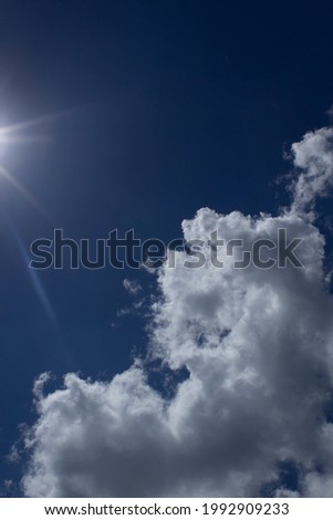 Blue sky with white abstract shape clouds and sun light up view