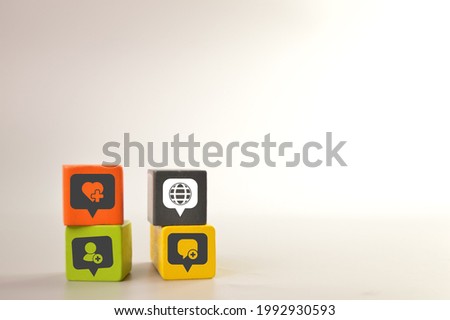 Wooden blocks with social media icons. Like button, add friends, chat and globe