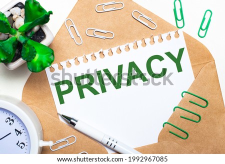 On a light background, an open envelope, a white alarm clock, a green plant, white and green paper clips, a white pen and a sheet of paper with the text PRIVACY