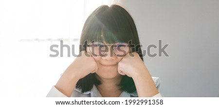 Banner Artwork Panorama close up to Asian HAPPY GLASSES girl face in  the bedroom with sunlight from the window behind her.