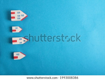 small homes on blue background isolated on blue background. Images contains copy space. Winter background