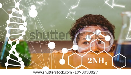 Composition of dna strand and elemental diagrams over child wearing safety glasses in science class. school, education and study concept digitally generated image.