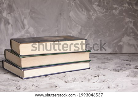 Stack of colorful books. An open book on a stack of books. The concept of education, international book day, success. Book, hardback colorful books on table. Education business concept.
