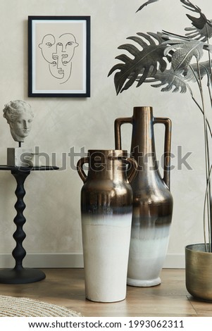 Stylish composition of eleganat living room interior with mock up poster frame, coffee table, two elegant designed vases, palm leaves and personal accessories. Neutral beige wall. Template.