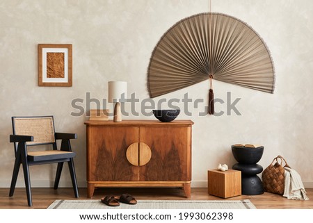 Interior design of neutral living room with stylish retro commode, mock up poster frame, cube, table lamp, decoration and elegant personal accessories in home decor. Template. Japandi concept.
