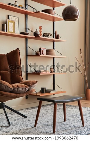 Interior design of living room with brown armchair, coffee table, wooden shelf, book, picture frame, decoration and elegant personal accessories in home decor. Template.