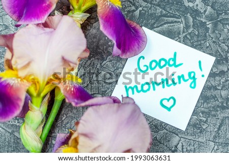 Purple irises and a "Good morning" note in close-up.