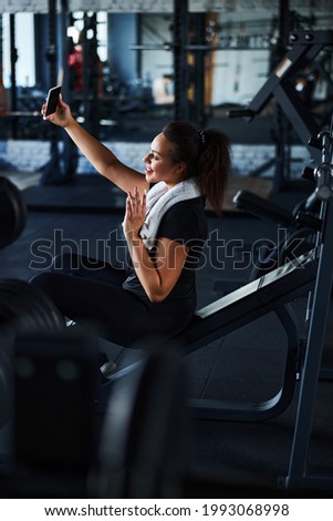 Merry female making video call from gym