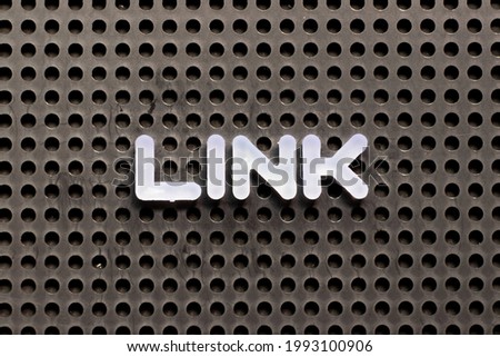 White color letter in word link on black pegboard background
