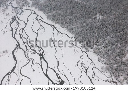 A river covered by ice and snow, an abstract picture of nature. Katun River in Russia.