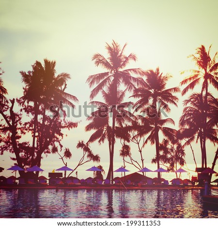 Tropical beach with palm trees and water reflections. Vintage instagram effect. Square composition.