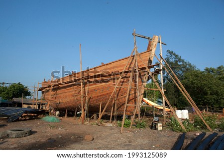 Boat in the traditional process of making in outdoor factory.