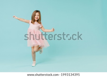 Full size body length little fun cute kid girl 5-6 years old wears pink dress dancing isolated on pastel blue color background child studio portrait. Mother's Day love family people lifestyle concept Royalty-Free Stock Photo #1993134395