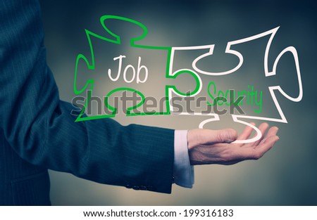 A Businessman's hand holding the words Job Security.