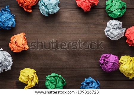crumpled colorful paper on wooden background creative process Royalty-Free Stock Photo #199316723