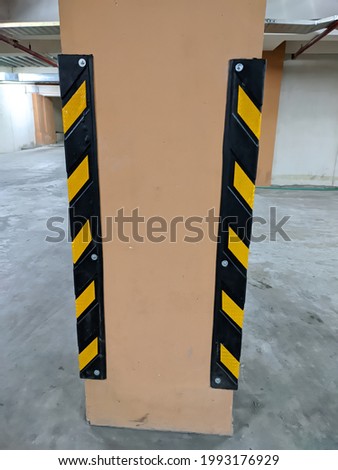 concrete pillars protected by fluorescent signs