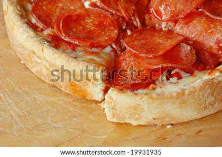 Sliced deep dish pepperoni pizza.l