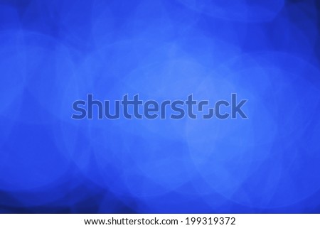 Blue abstract background with defocused bokeh lights