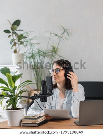 podcaster creates content, European woman records podcast with microphone and headphones, Caucasian woman in recording studio records voice for commercials or audio book, confident woman radio host