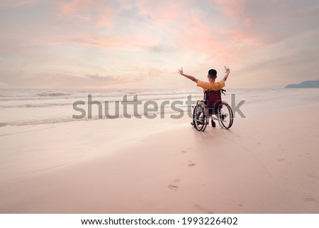 Asian disabled child on wheelchair is fun with activity on the beach in family holiday travel and learning about nature around the sea beach, Lifestyle in the education age,Happy disabled kid concept. Royalty-Free Stock Photo #1993226402