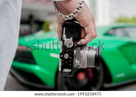 Tourist hold digital camera (mirrorless camera) for take a photo or video