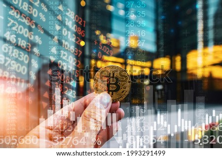 Bitcoin gold coin and defocused chart and financial district building background
