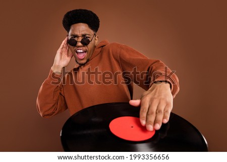 Photo of funky short hairdo young guy play disc dress spectacles sportswear isolated on brown color background Royalty-Free Stock Photo #1993356656