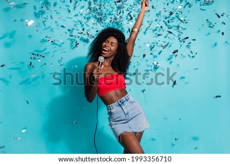 Photo of sweet charming dark skin lady pointing singing karaoke closed eyes isolated blue color background
