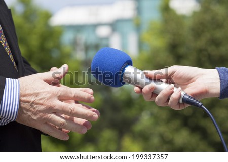 Reporter interviewing a businessman 