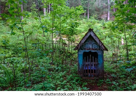 nice old wayside shrine in the green forest while hiking