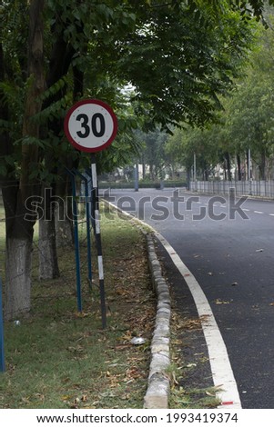30 kilometers per hour speed limit road sign in a street.
