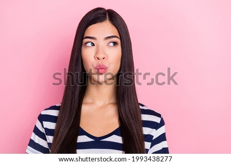 Photo of flirty long hairdo young millennial lady blow kiss empty space wear striped t-shirt isolated on pastel pink color background