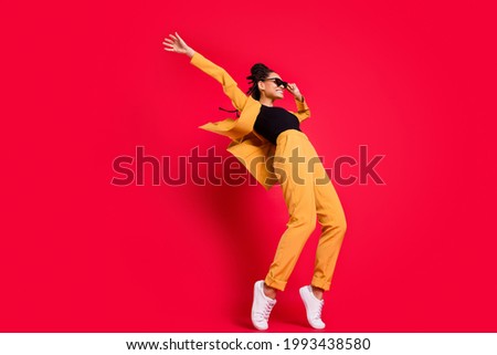 Full size profile photo of funny lady dance wear eyewear yellow suit isolated on vivid red color background Royalty-Free Stock Photo #1993438580