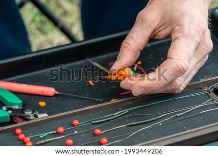 Close up photo of male hand with fishing gear 