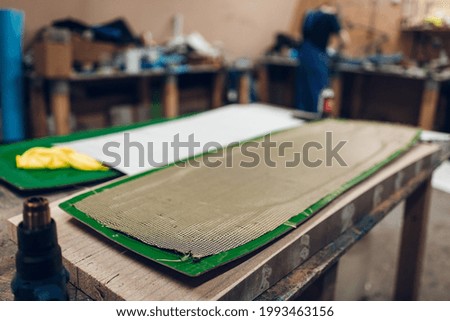The kevlar part is prepared for baking in the oven. Carbon part production process 

