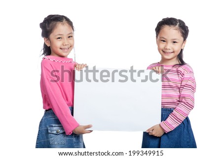 Asian twin sisters very happy hold a blank sign