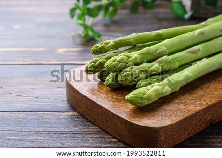 Green asparagus isolated on wooden table