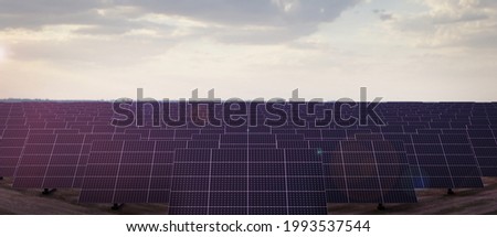 green energy or clean energy concept, 
solar panels generation equipment in the light of the rising sun Royalty-Free Stock Photo #1993537544