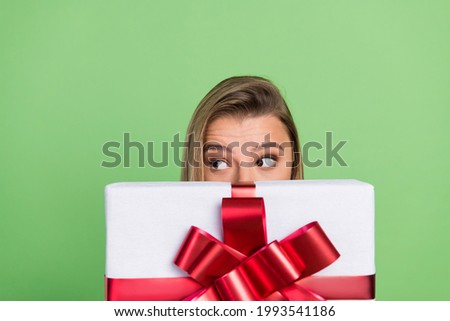 Photo portrait girl hiding face behind big present box isolated pastel green color background Royalty-Free Stock Photo #1993541186