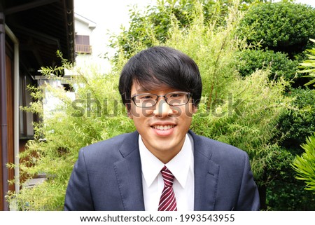 Japanese businessman. A smiling Asian man with glasses.