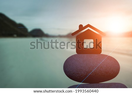 Small toy house on sea beach at sunset, family travel and summer vacation