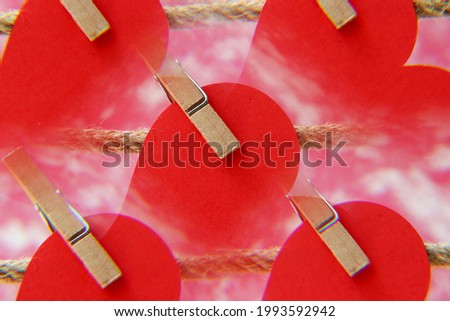red paper hearts hanging on clothesline