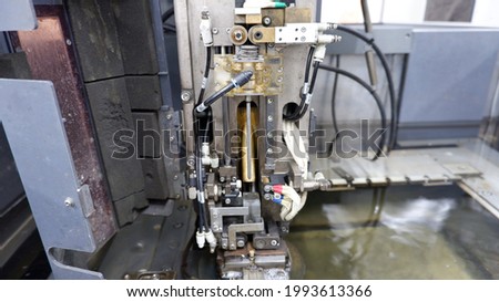 Photos of machine operation in steel cutting room to cut steel in industrial plants as mold design of some electronic systems.