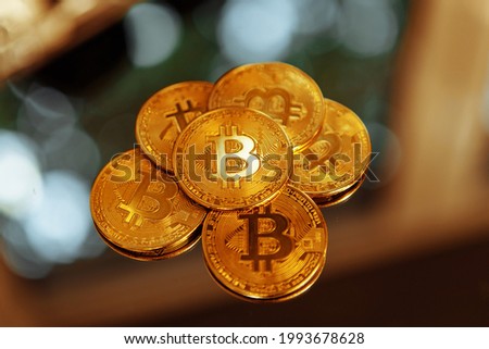 Bitcoins on a mirror background. Crypto fever. High quality photo