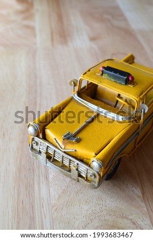 vintage car model yellow fabricated from steel on black background
