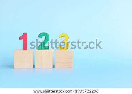 Colorful 123 numbers on wooden blocks in blue background with copy space. Start of child or kid learning counting concept.	 Royalty-Free Stock Photo #1993722296