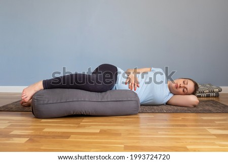 Pregnant woman lying in Shavasana, resting after practice, meditating Royalty-Free Stock Photo #1993724720
